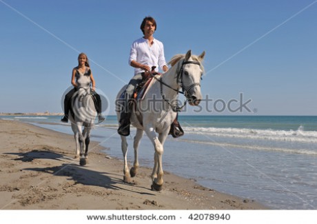 stock-photo-father-and-daughter-are-riding-with-their-white-horses-on-the-beach-42078940